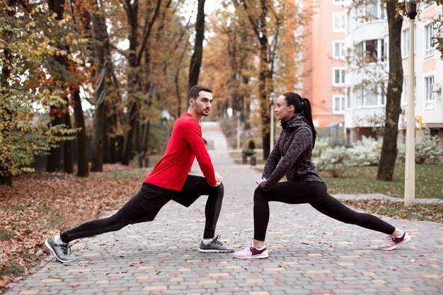 Full shot people stretching in nature