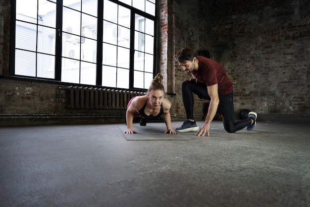 Full shot people training with yoga mat