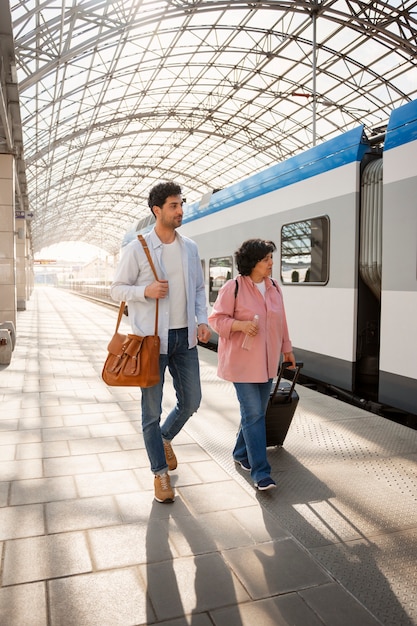 Free photo full shot people traveling by train