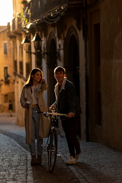 Full shot people walking with bicycle