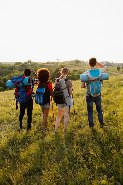 Full shot people wearing backpacks