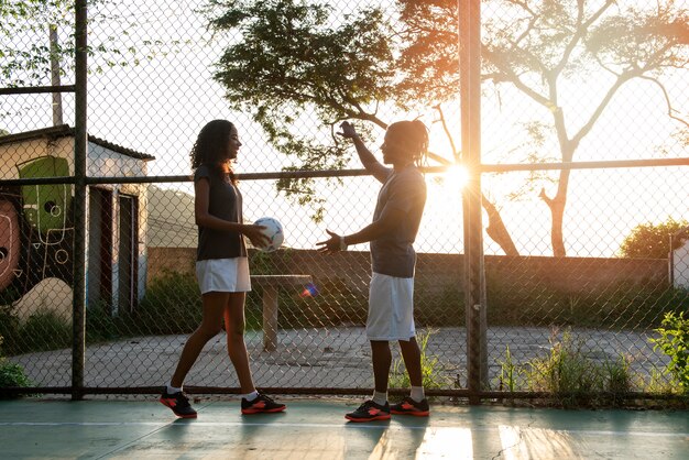 Full shot people with soccer ball