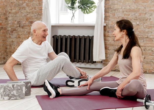 Free photo full shot people on yoga mats