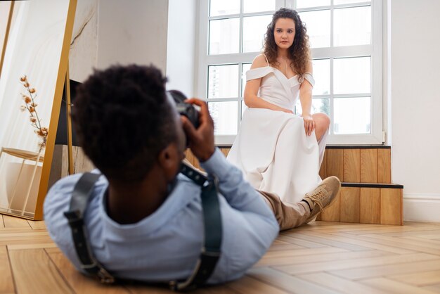 Full shot photographer taking photos of bride