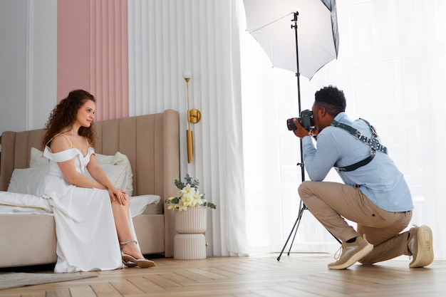 Full shot photographer taking photos of bride