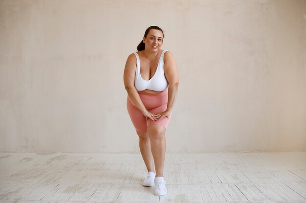 Full shot plus size model posing in studio