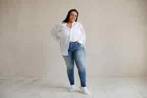 Free photo full shot plus size model posing in studio