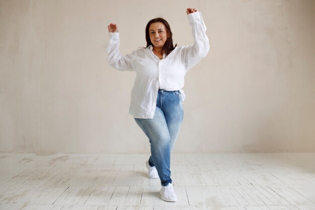 Full shot plus size model posing in studio