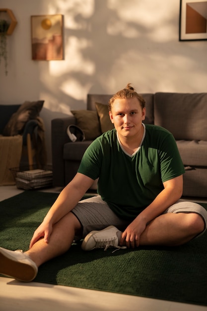 Free photo full shot plus-sized man stretching at home