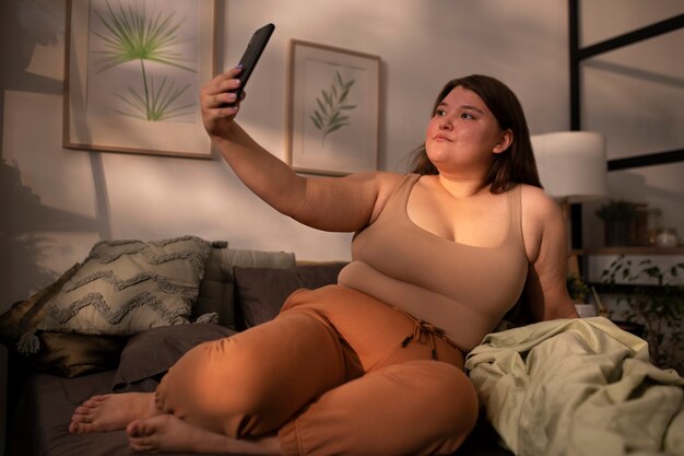 Full shot plus-sized woman in homewear