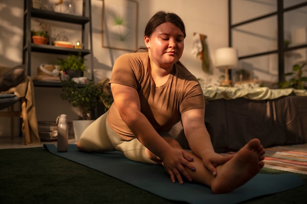 Full shot plus-sized woman stretching