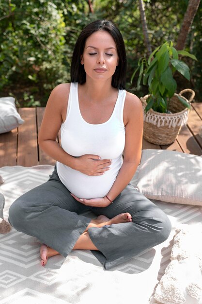 Full shot pregnant woman outside