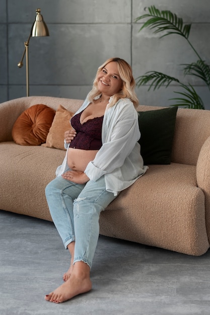 Full shot pregnant woman posing in studio