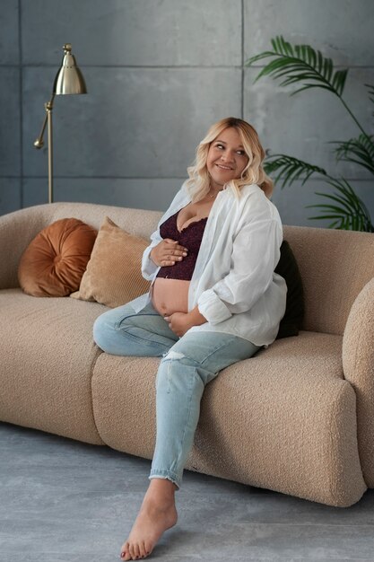 Full shot pregnant woman posing in studio