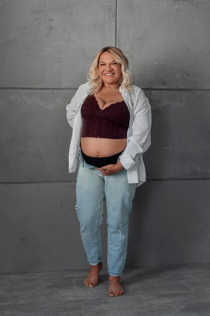 Full shot pregnant woman posing in studio