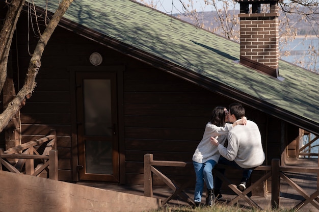 Full shot romantic couple kissing outdoors