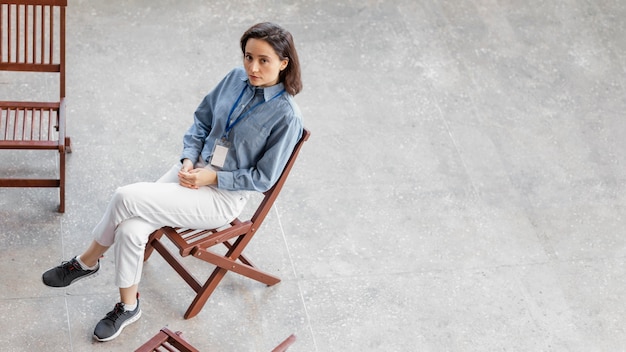 Full shot sad woman sitting on chair