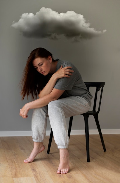 Full shot sad woman sitting on chair