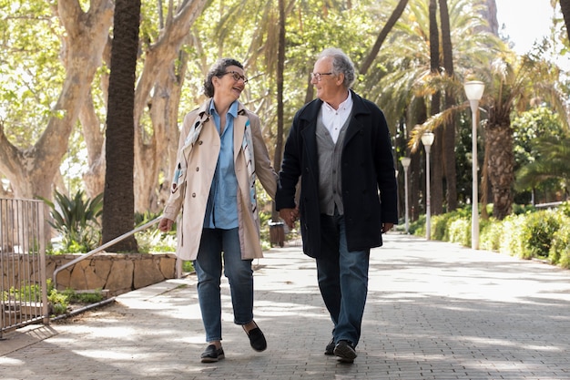 Full shot senior people holding hands