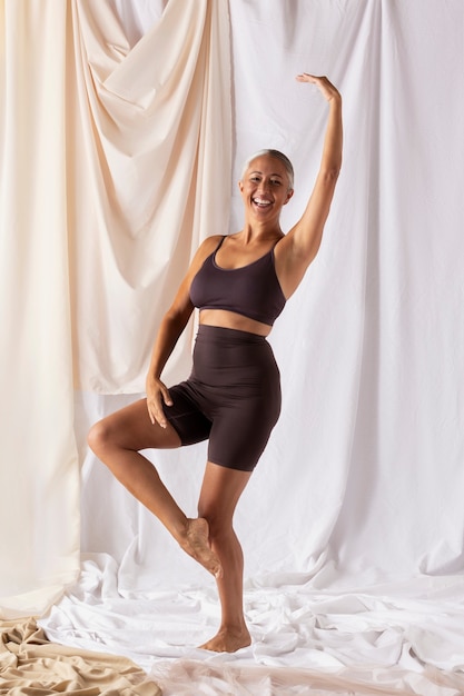 Full shot senior woman posing in studio