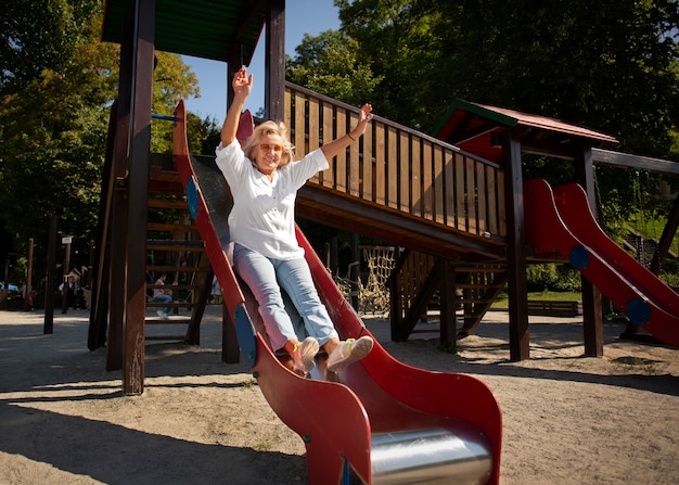 Full shot senior woman on slide