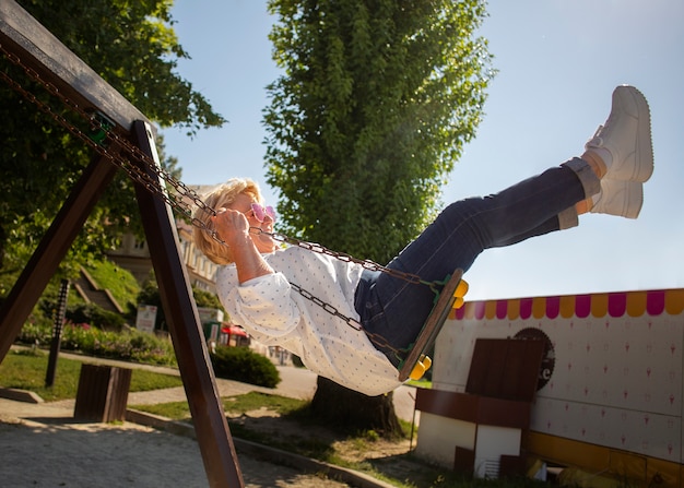 Full shot senior woman on swing