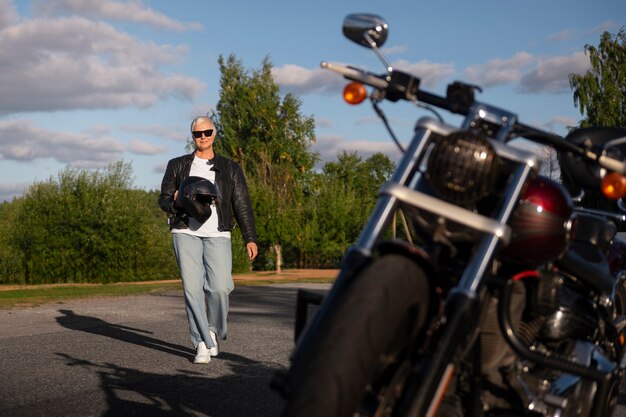 Full shot senior woman with motorcycle