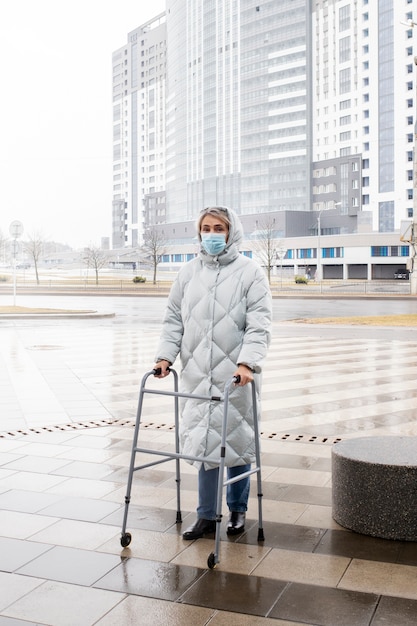 Full shot senior woman with walking frame