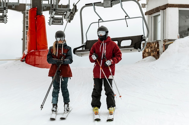 Full shot skiers near chairlift