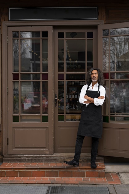 Full shot small business owner standing outdoors