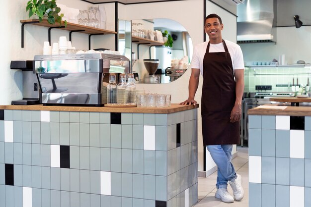 Full shot smiley barista