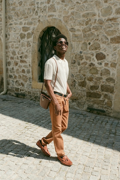 Full shot smiley black man walking outdoors