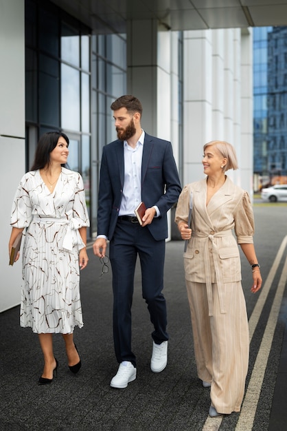 Full shot smiley colleagues going to work