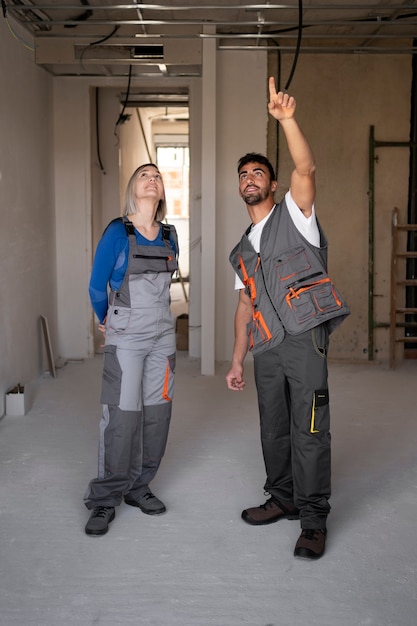 Full shot smiley construction workers at job