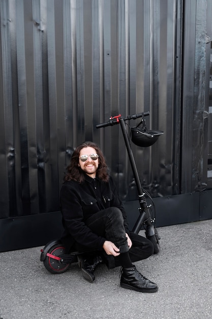 Foto gratuita uomo fresco e sorridente del colpo pieno sullo scooter