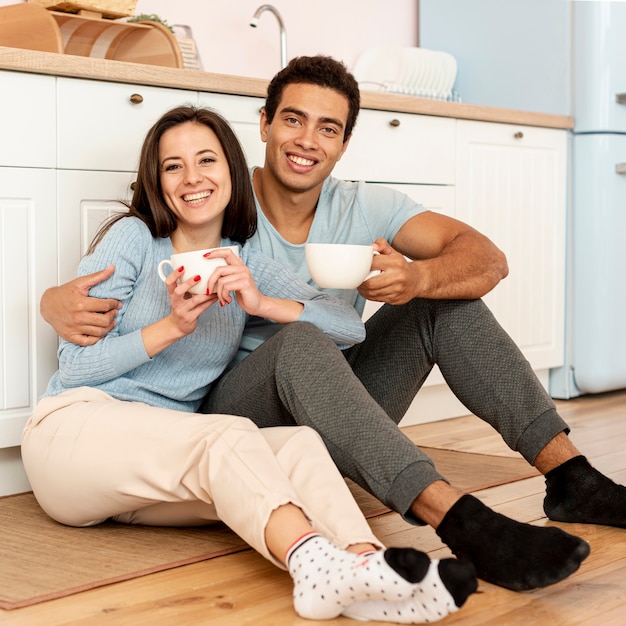 Full shot smiley couple posing together