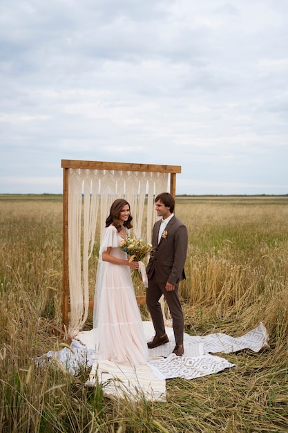 Free photo full shot smiley couple with flowers