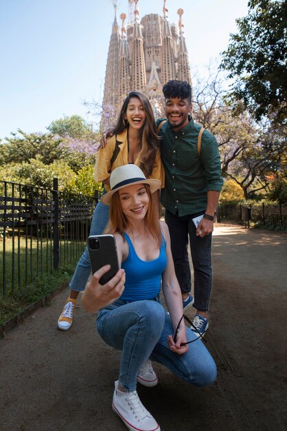 full shot smiley friends taking selfie