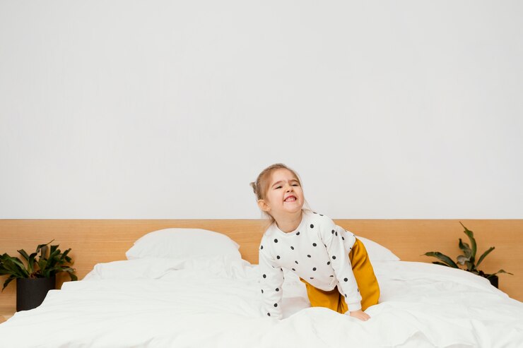 Free Photo full shot smiley girl standing on bed