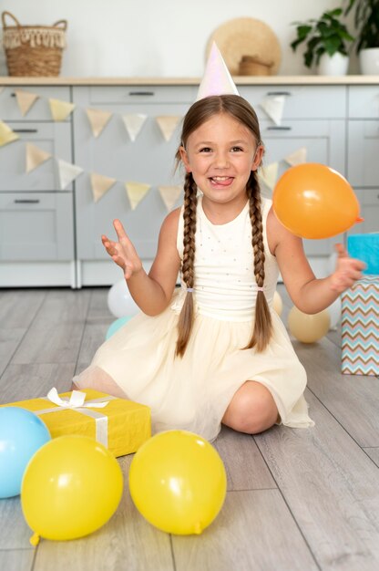 Full shot smiley girl with party hat