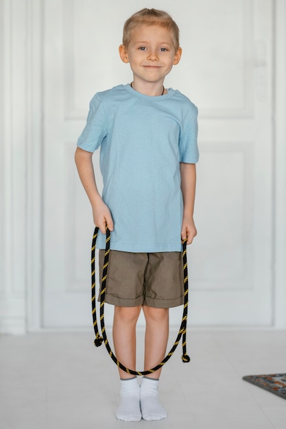 Full shot smiley kid holding jumping rope