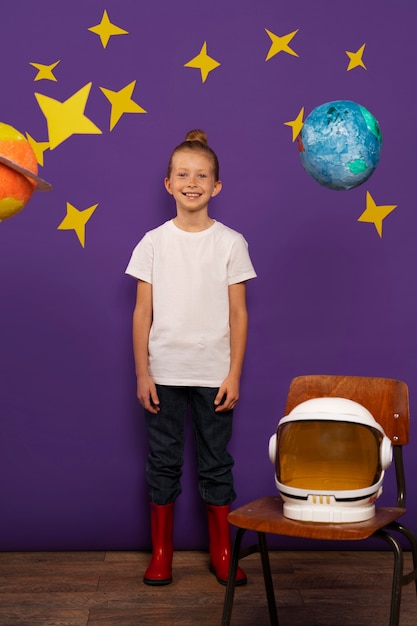 Free photo full shot smiley kid posing indoors