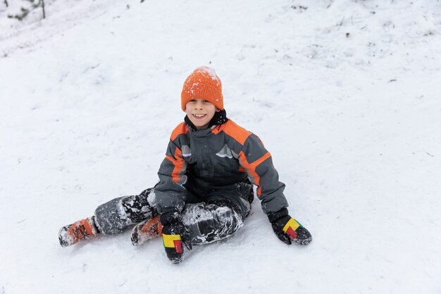 Full shot smiley kid sitting outdoors