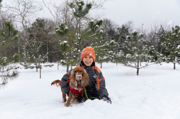 Full shot smiley kid sitting with dog