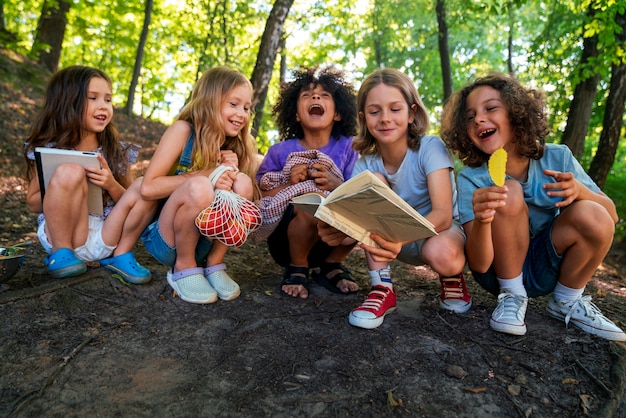 Full shot smiley kids in forest