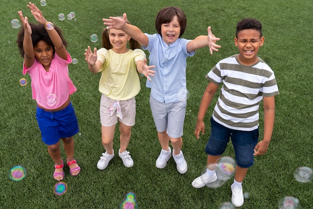 full shot smiley kids outdoors
