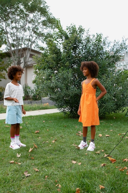 Free photo full shot smiley kids playing outdoors