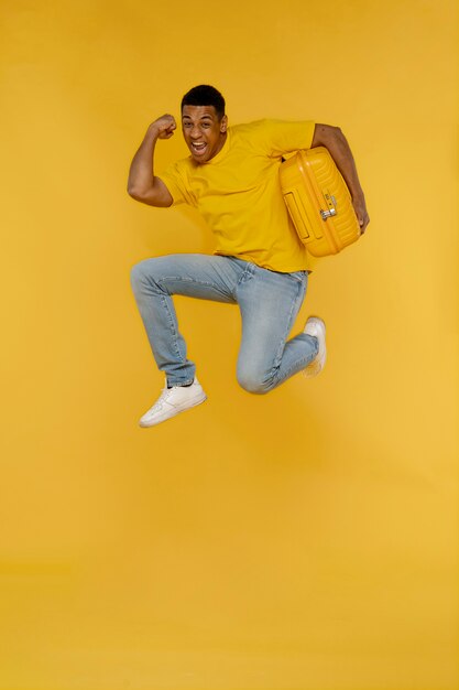 Full shot smiley man holding baggage