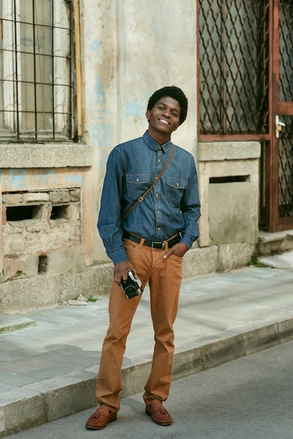 Full shot smiley man holding photo camera