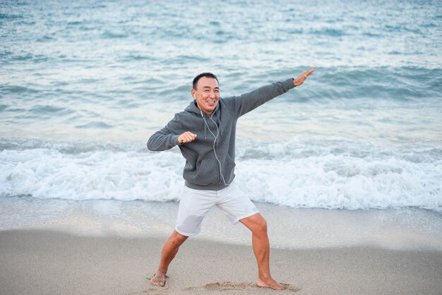 Full shot smiley man at seaside